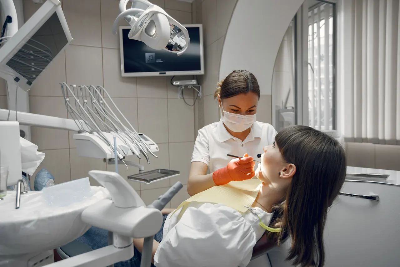 A dental clinician treating a young patient